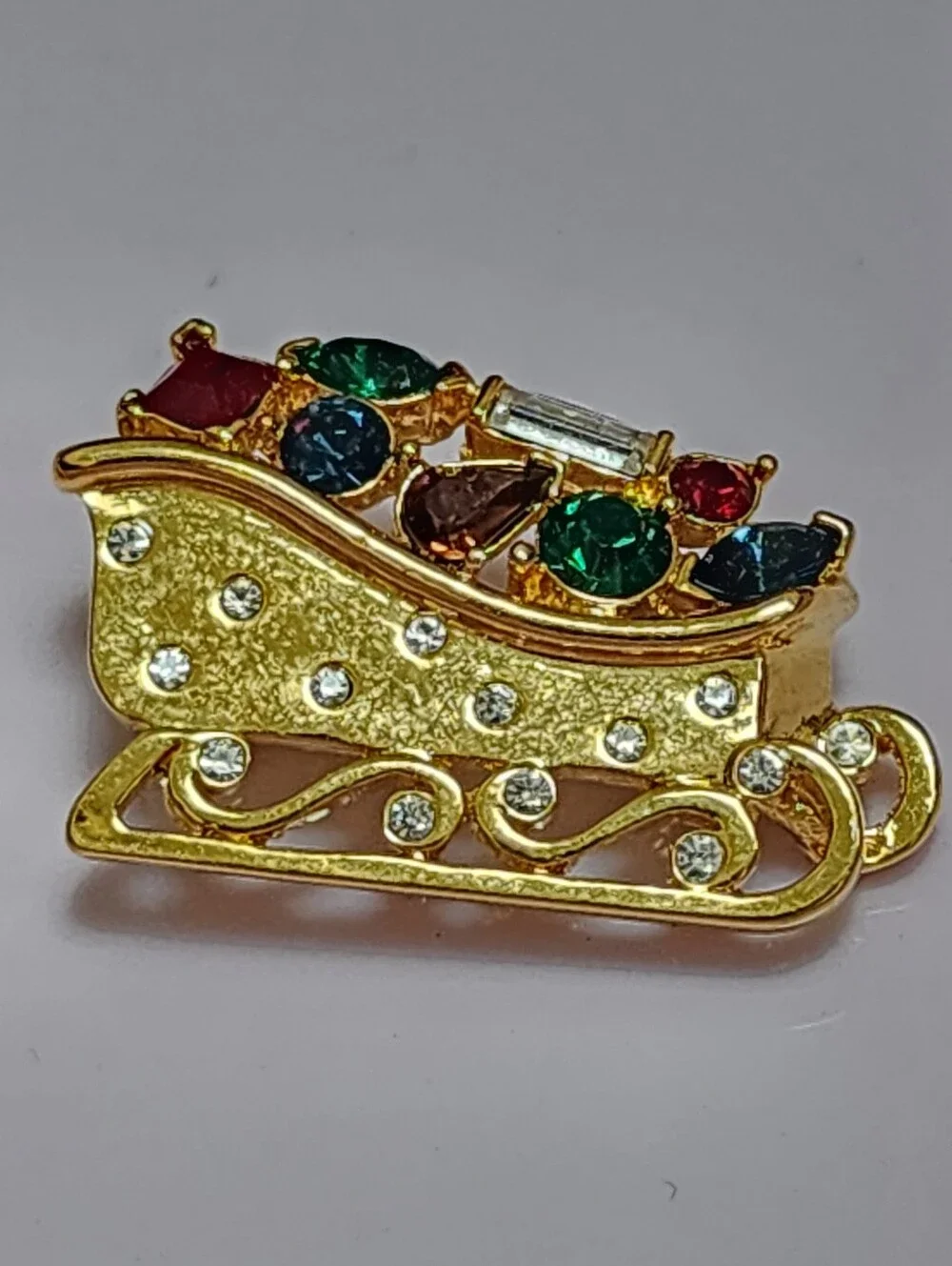 Monet Gold-tone Festive Sleigh Brooch with Multicolor Rhinestones